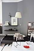 Candlesticks and strawberries on table in modern living room in shades of grey