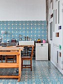 Ornate, blue and white wall and floor tiles in loft-apartment kitchen