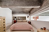 Ribbon window, ethnic art and ribbed concrete ceiling in bedroom