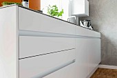 A kitchen counter with white cupboards