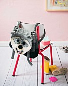 A hand-crocheted children's racoon rucksack made from felting wool