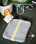 A homemade knitted tablet cover made from felting wool