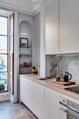 Fitted kitchen and arched niche in renovated townhouse apartment