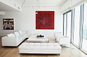 Sofas, coffee table and red artwork in modern living room