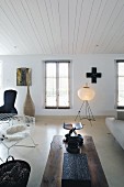 Eclectic living room with rustic coffee table in front of contemporary floor lamp
