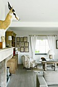 Hunting trophy and comfortable wing-back chair in rustic living area
