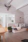 Comfortable couch in wintry wooden house