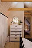 Christmas decorations on white chest of drawers in bedroom with vintage ambiance
