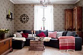 Sofa combination with various scatter cushions and sheepskin blankets in Scandinavian living room