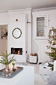 White, festive living room with Swedish tiled stove