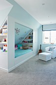 Cubby bed, shelves, lounge chair and grey carpet in child's bedroom
