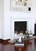 pebbles and candles in white fireplace