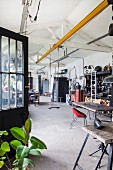 Swing hung from white beam structure in retro workshop