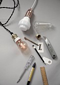 Vintage-style light bulbs and craft materials on grey surface