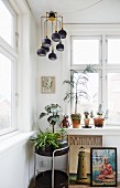 Retro lamp above houseplants on serving trolley