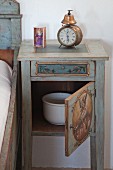 Chamber pot in traditionally painted bedside cabinet