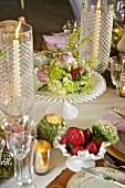 Flowers and candle lantern on festively set table