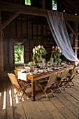 Festive table set in rustic style in barn