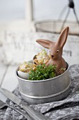 Cress, small snacks and chocolate Easter bunny in tin