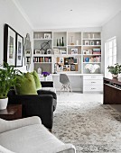 White shelving with integrated desk in living area