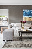 Landscape painting on grey wall in elegant living area