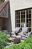 Rustic furniture in pleasant seating area on terrace outside house