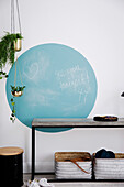 Blue circle with blackboard paint above the console table in the hallway