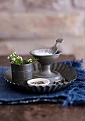 Candlestick used as salt cellar on flan tin used as tray
