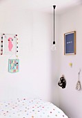 Girls room with dotted bedding, light bulb pendant lamp and wall decoration