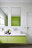 Modern bathroom with green vanity and tile mirror