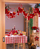 Advent calendar of red, filled bags with child