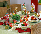 Table decoration with malus (apple), apples under glass bells