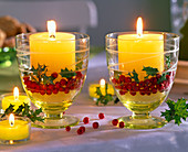 Glasses with yellow candles