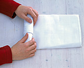 White napkin rolled as a cutlery bag