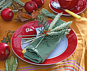 Green napkin with bunch of triticum (wheat)