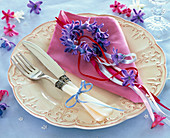 Wreath of blue Hyacinthus flowers on pink napkin