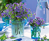 Bouquets of Brunnera macrophylla in blue glass vases