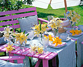 Table decoration with yellow Lilium, light blue covered coffee table
