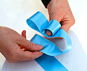 Tying a ribbon