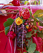Autumn, table decoration with roses and grapes