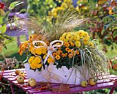 Box with chrysanthemums and grasses
