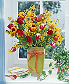 Bouquet made of forsythia branches and tulips stems