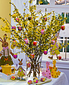 Forsythia bouquet decorated with colorful Easter eggs