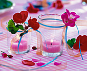 Pelargonium flowers on small lanterns with pink tealights