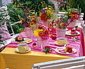 Table decoration with Zinnia bouquets, Solidago