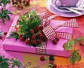 Gift with bouquet made of rubus (blackberry), leaves and berries