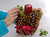 Red candles with spruce cones