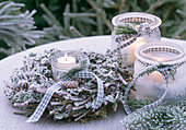 Wreath of twigs with lichen and cones, lanterns in hoarfrost