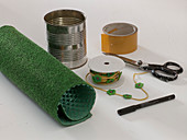 Can with artificial turf pasted