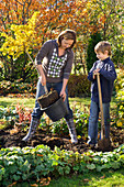 Mother and son planting Ginkgo biloba (Ginkgo tree)